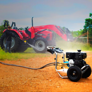 A man cleaning tractor tires with a SIMPSON® premium pressure washer